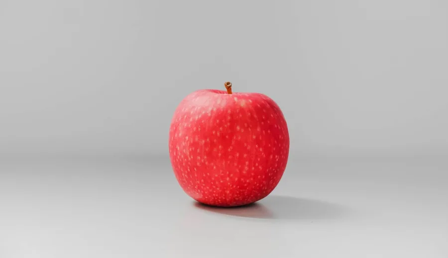 Freshly sliced crisp red apple with a side of natural creamy peanut butter