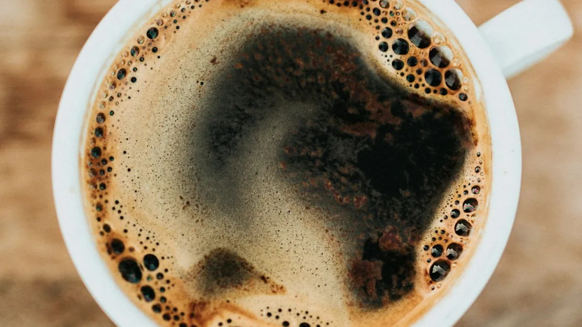 Freshly brewed hot coffee alongside iced tea and caffeinated beverage glasses