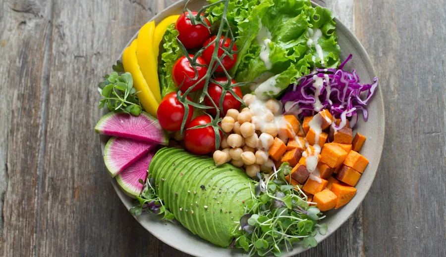 Nutrient-dense plant protein bowl with roasted chickpeas, quinoa, avocado, and leafy greens