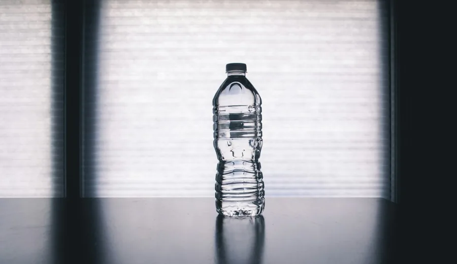 Clear glass pitcher filled with filtered water and sliced fresh citrus fruits