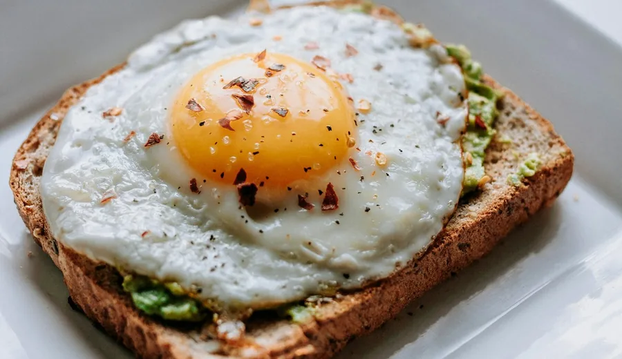 Gentle first meal to break a fast with poached eggs, ripe avocado, and baby spinach