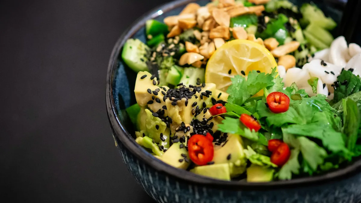 High-protein food spread including grilled chicken, eggs, Greek yogurt, lentils, tofu, and almonds