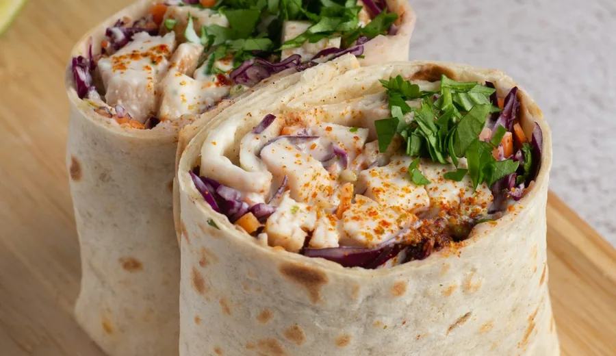 Golden turmeric scrambled tofu wrap with avocado, black beans, and diced tomatoes