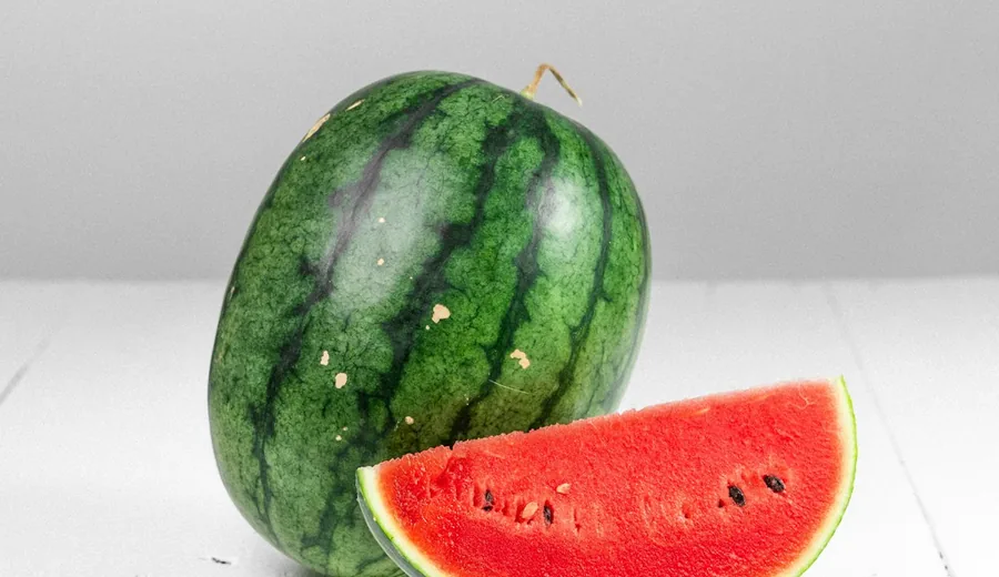 Freshly sliced watermelon, cucumber ribbons, strawberries, and citrus wedges for natural hydration